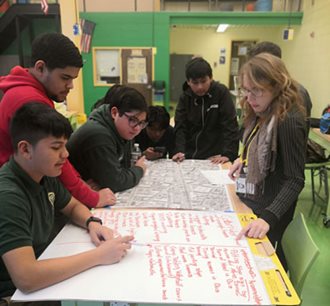 Students look at a map of Main Avenue in Passaic.