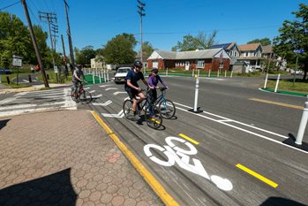 Three cyclists ride in a temporary bicycle lane