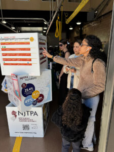 An interpreter guides a woman and her daughter through questions to gather public input for the Connecting Communities long-range transportation plan during an event inside the Paterson Fire Department Headquarters..
