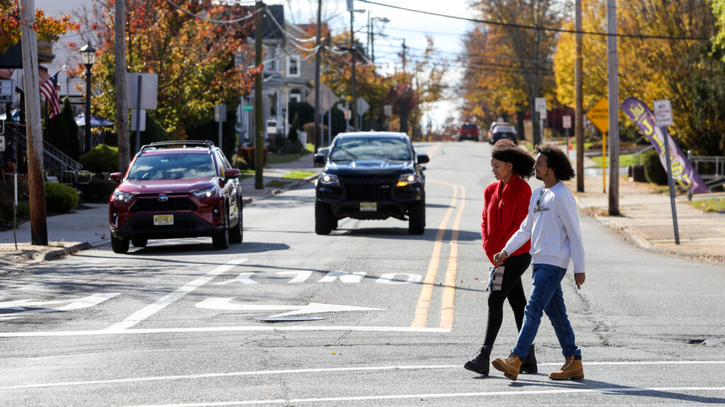 Pedestrians walking across crosswalk.