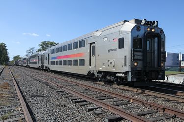Multi-level NJ TRANSIT train travels through Bound Brook