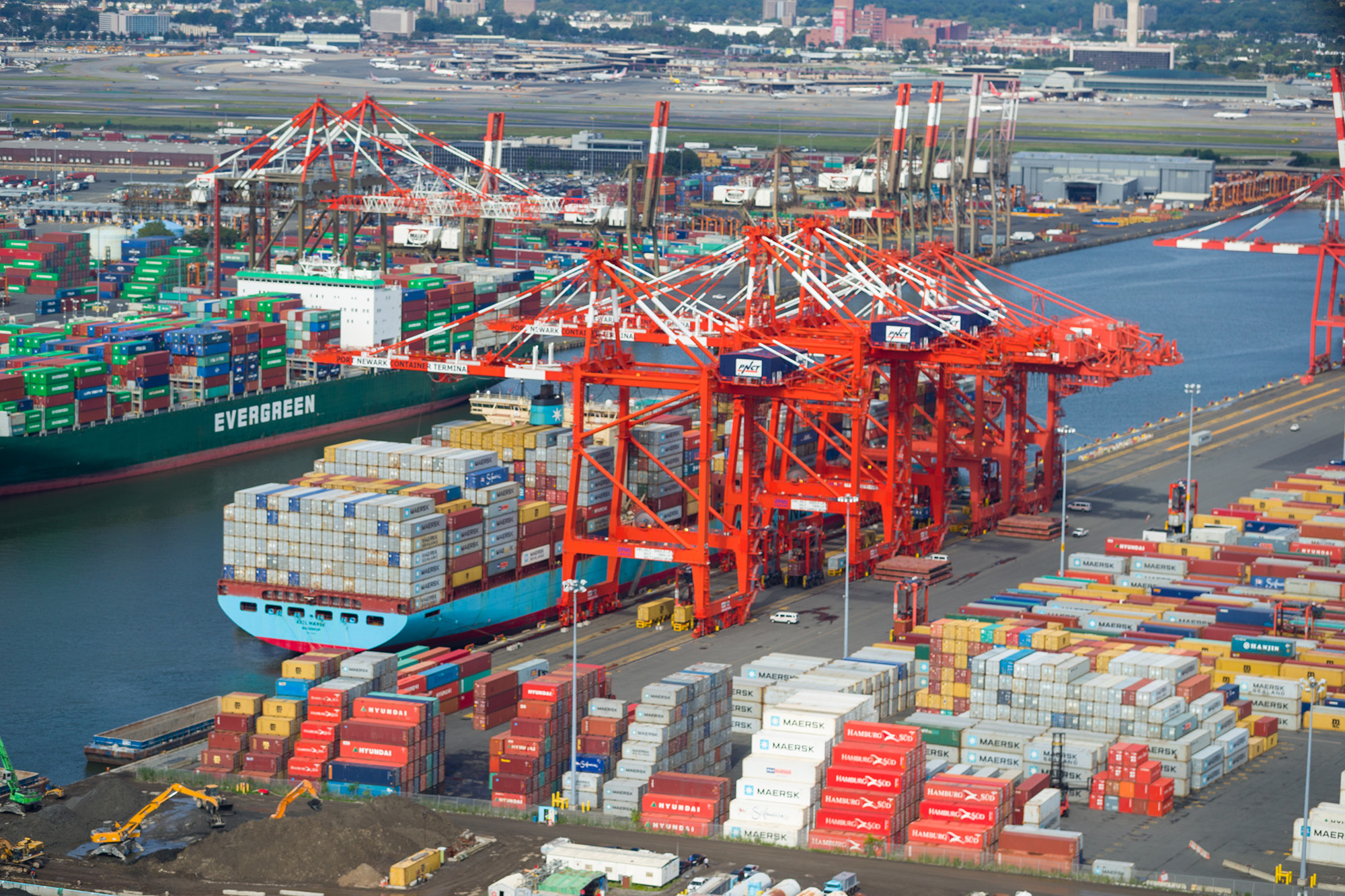 Cranes remove containers from a large ship at the Port in New Jersey.