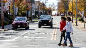 Young kids crossing the street.