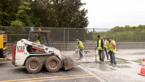 Construction workers add concrete to a bridge deck.