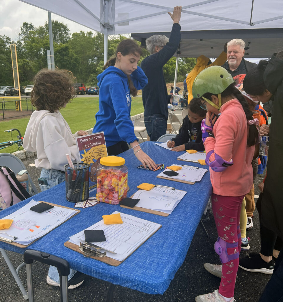 Children participate in a coloring activity to provide input about their vision for the future of transportation.