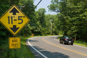 Car passes sign warning of 11-foot, 5-inch bridge clearance in 600 feet