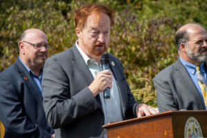 Commissioner John Bartlett speaks at podium during Highlands Rail Trail ribbon cutting ceremoney