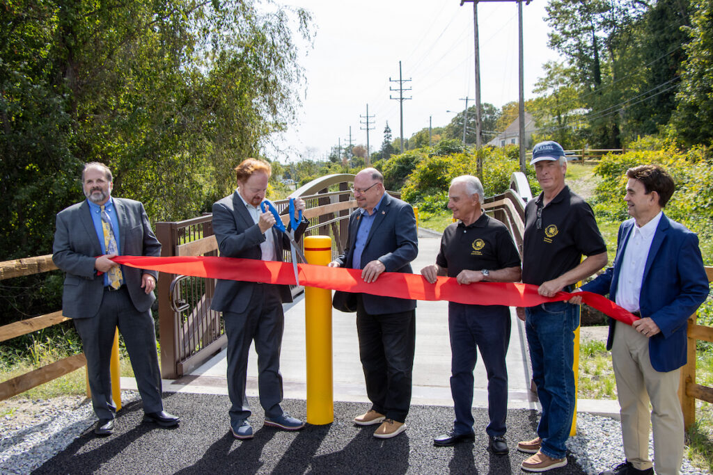 Officials gather to cut ceremonial ribbon for Highlands Rail Trail.