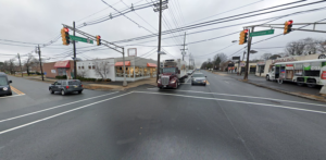 Truck and other vehicles wait for signal at Plainfield Avenue.