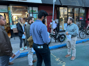 Man leads group of young adults on tour of urban area.