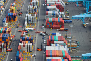 Aerial view of trucks traversing Port of New York and New Jersey in Newark-Elizabeth amid containers.