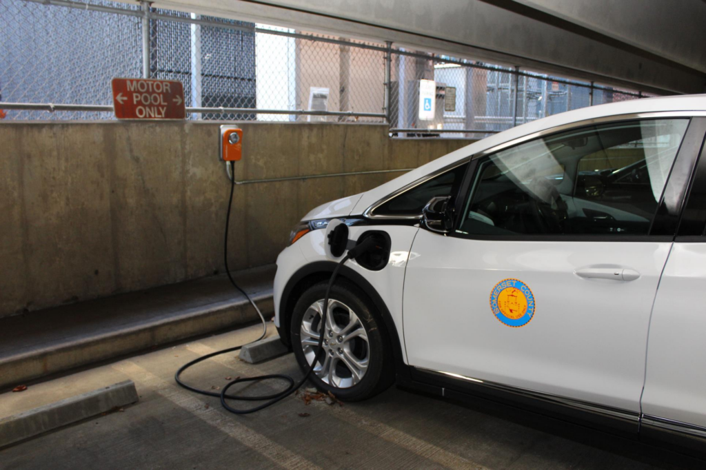 Somerset County vehicle plugged into electric charger in parking garage.