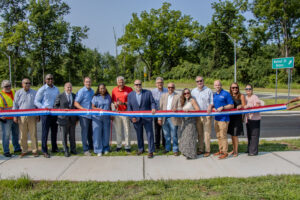 Officials hold a ribbon at the new Livingston roundabout prior to cutting the ribbon to celebrate the completion of the safety project.